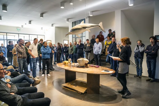 Staff gathering around a large table. Photo