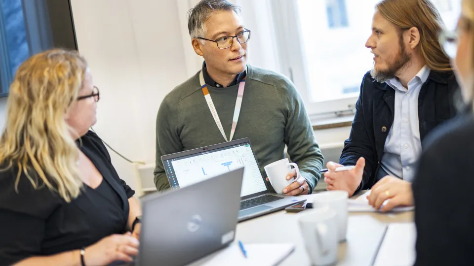 Four people in a meeting discussing an idea.